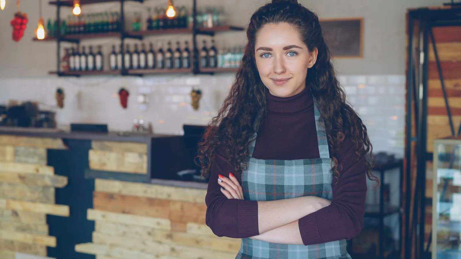 Small business cafe owner standing inside a retail hospitality store, representing a franchise or MBO purchase