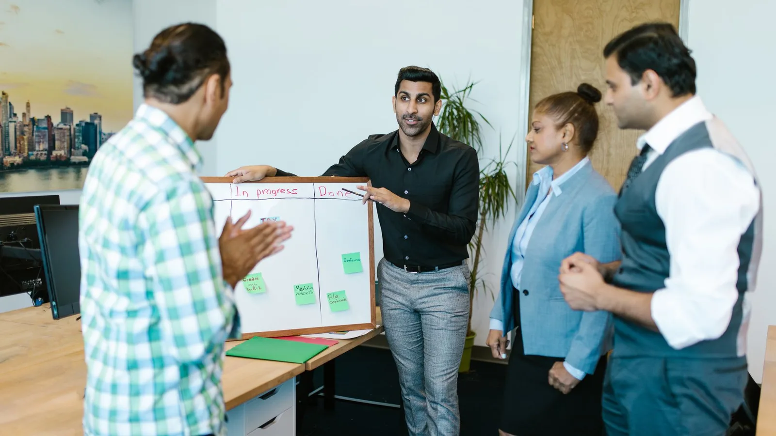 Corporate advisory team planning a multi-tier business acquisition capital structure on a whiteboard