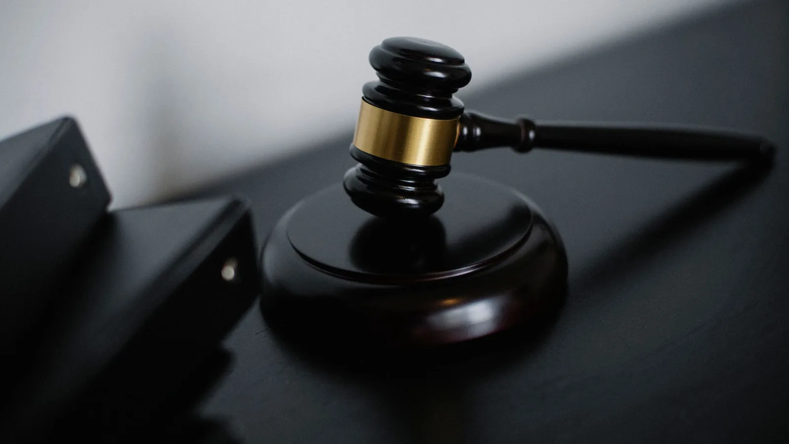 Auctioneer wooden ceremonial gavel on a desk with legal property documents for commercial auction finance in New Zealand