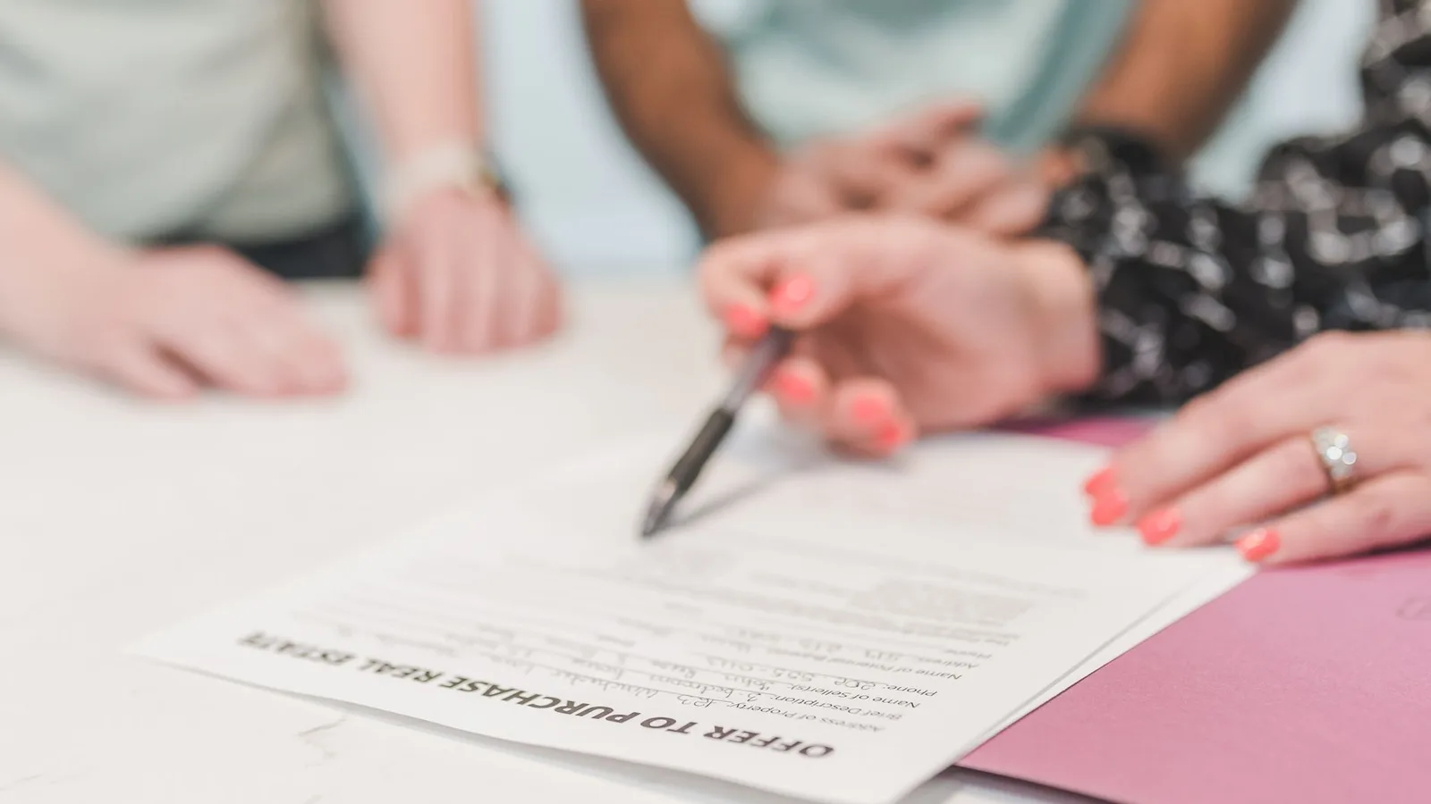 Business people reviewing and signing an unconditional commercial property purchase contract in New Zealand
