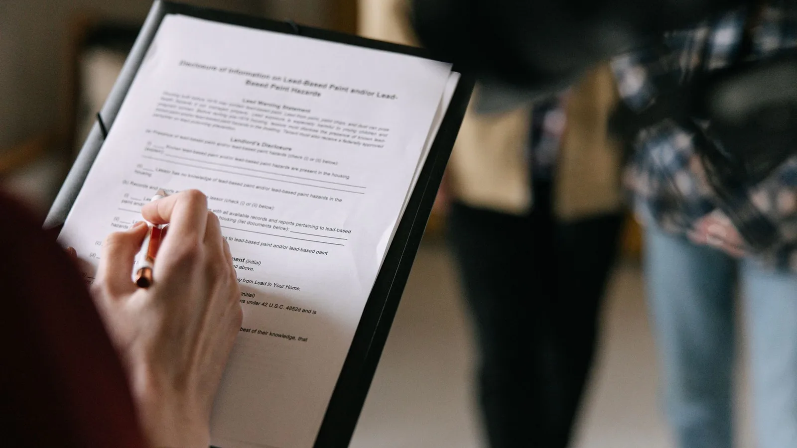 Business partners reviewing commercial lease agreement and tenancy paperwork in New Zealand