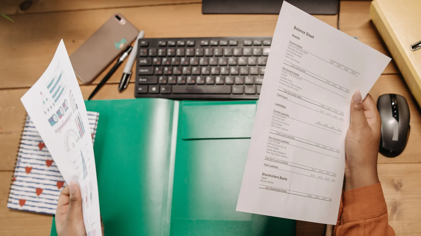 Financial documents laid out on an office desk, representing the paperwork required to refinance a commercial mortgage in NZ