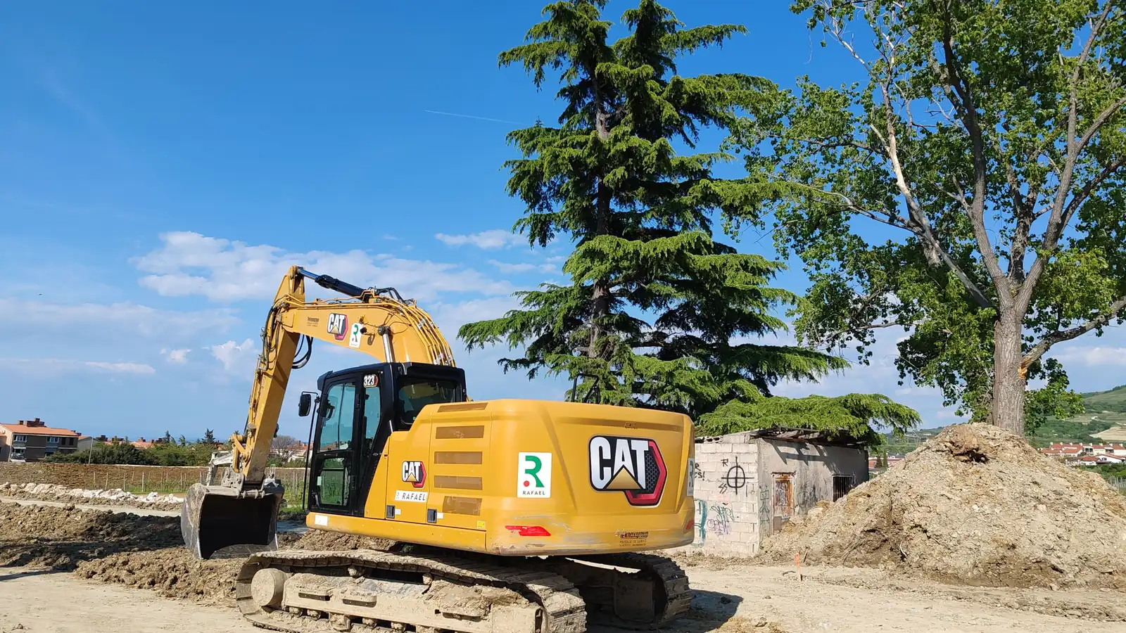 Yellow excavator on a construction site under a clear blue sky, the type of machine funded through construction equipment financing in NZ