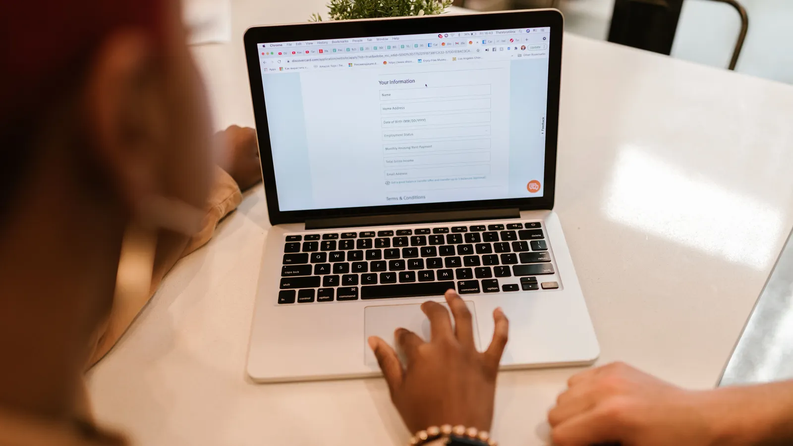 Person filling out an online finance application on a laptop