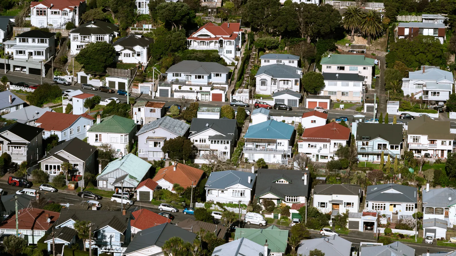 Aerial view of a quiet suburban street, representing personal-use borrowing that falls outside commercial EV finance