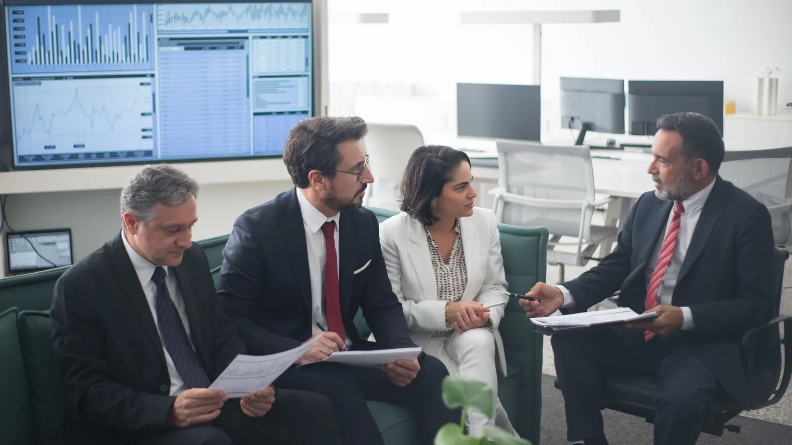 Group of business professionals discussing financial strategies around a table