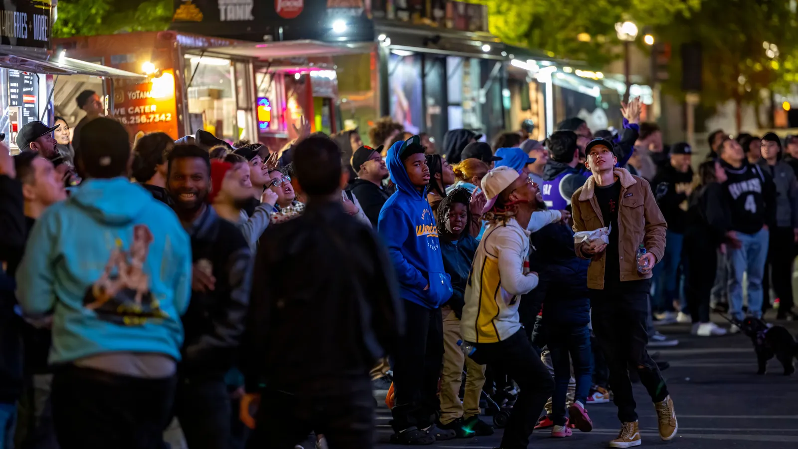 Crowd gathered around brightly lit food trucks at a night market, the type of business funded through food truck financing in NZ