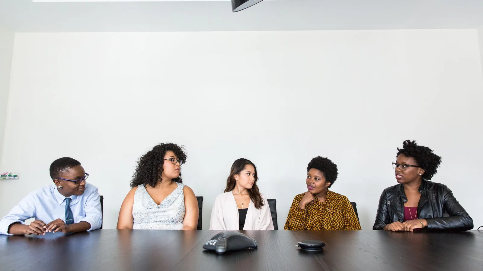 A professional group having a finance meeting in a modern commercial office setting