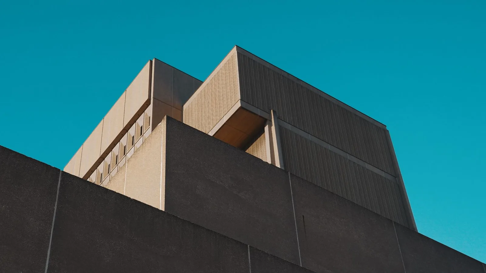 Striking modern concrete architectural structure against a vibrant sky