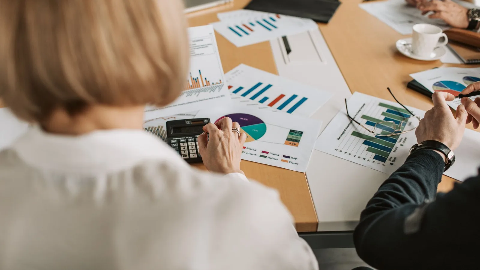 Financial advisors reviewing loan documents and terms with business clients