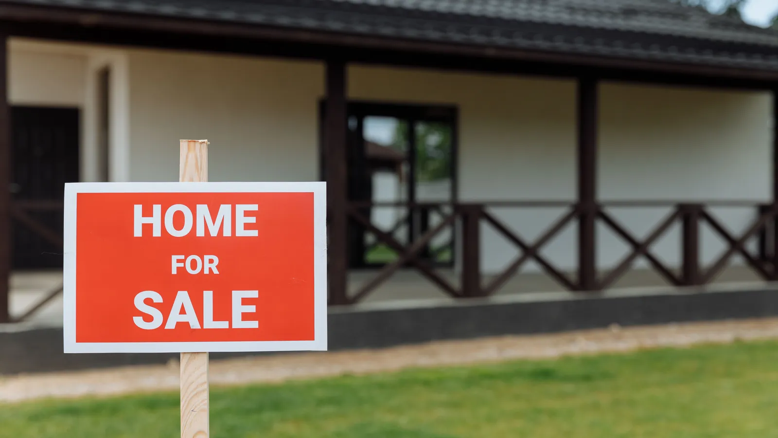 Home for sale with a spacious lawn and veranda