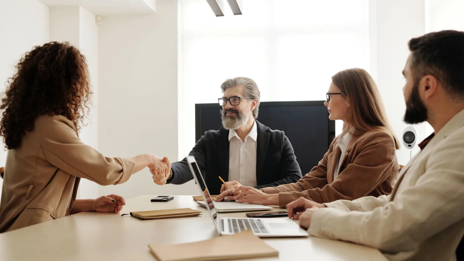 Business partners agreeing on commercial loan terms in a boardroom