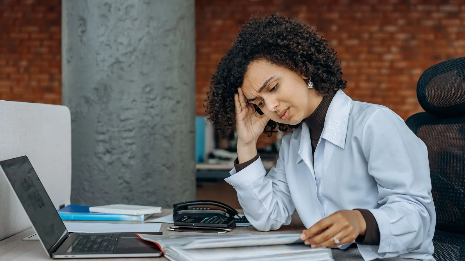 Business owner reviewing financial documents and IRD tax notices in an office