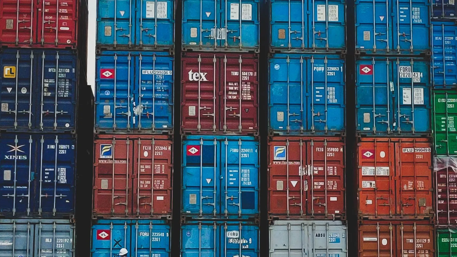 Stacked shipping cargo containers at port freight terminal