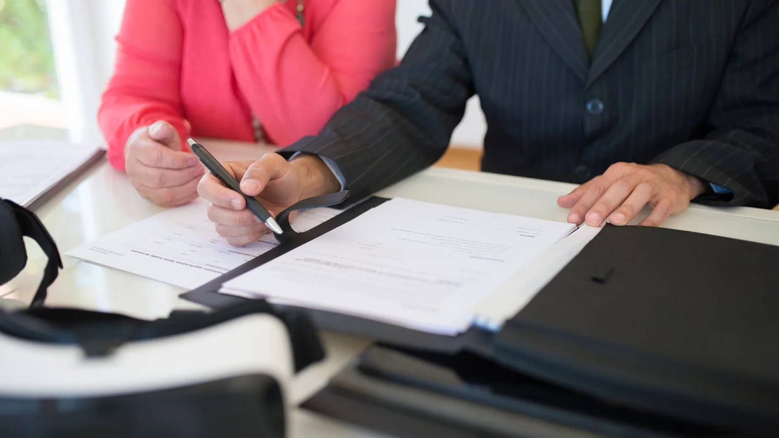 Business professionals reviewing international trade contracts and documentation on office desk