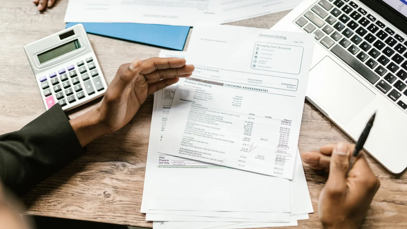 Financial documents and calculator on desk analyzing business supply chain accounts