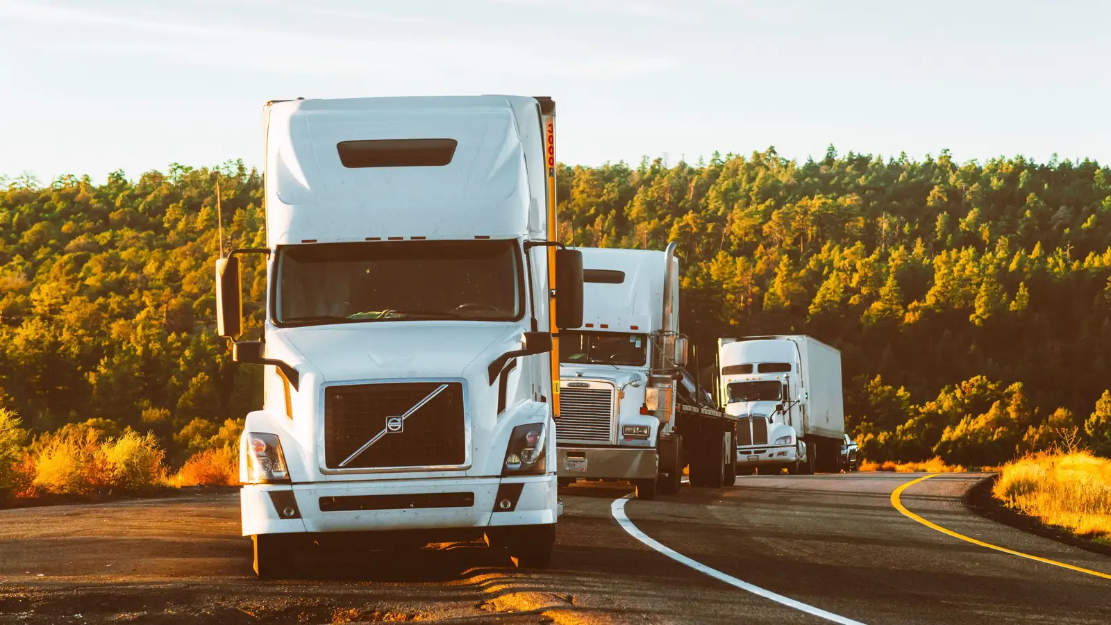 White semi-truck travelling along an open highway