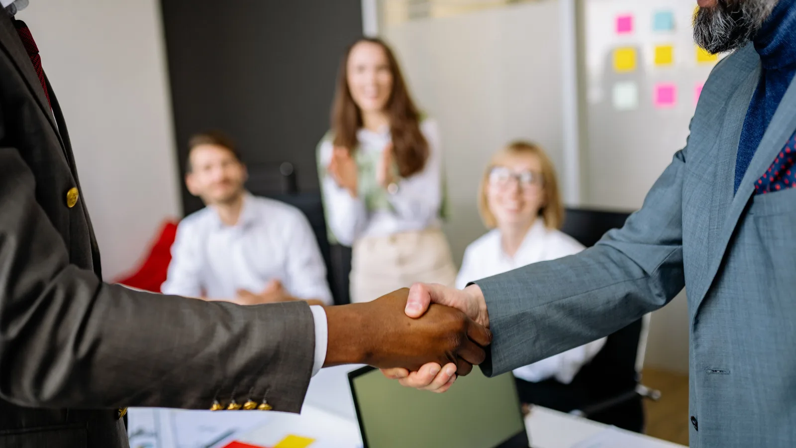 Business partners shaking hands in a modern office following approval of non-bank working capital finance