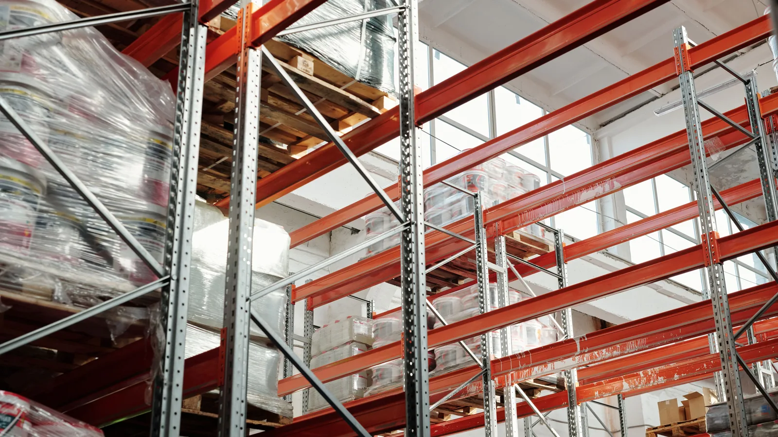 Bright modern commercial warehouse with pallets and storage racks for logistics and inventory management in New Zealand