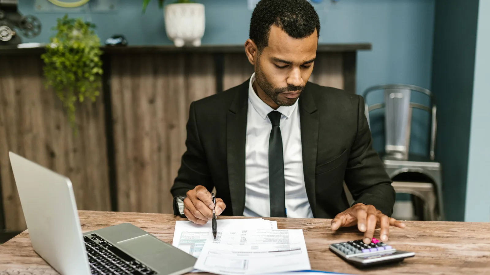 Business owner reviewing cash flow statements and debtor ledgers for working capital loan approval